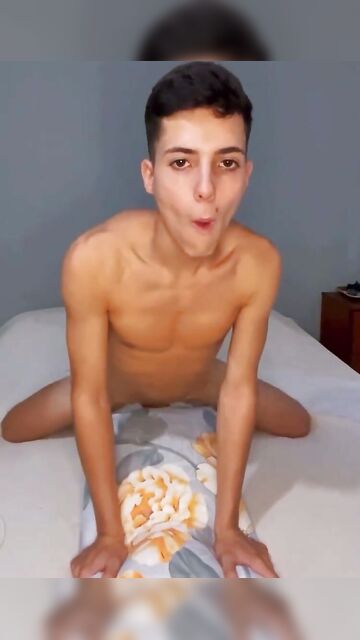 Beautiful naked 18-year-old guy fucks a pillow in his room