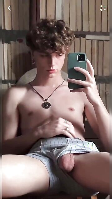 Curly hair angelic twink boy plays with his hard cock