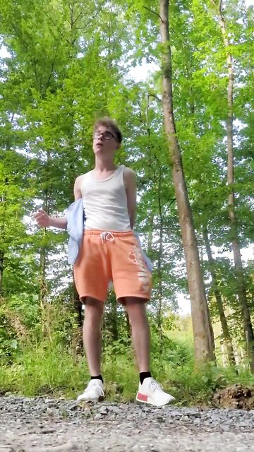 Blond cute guy gets naked and jerks off outdoor in the forest